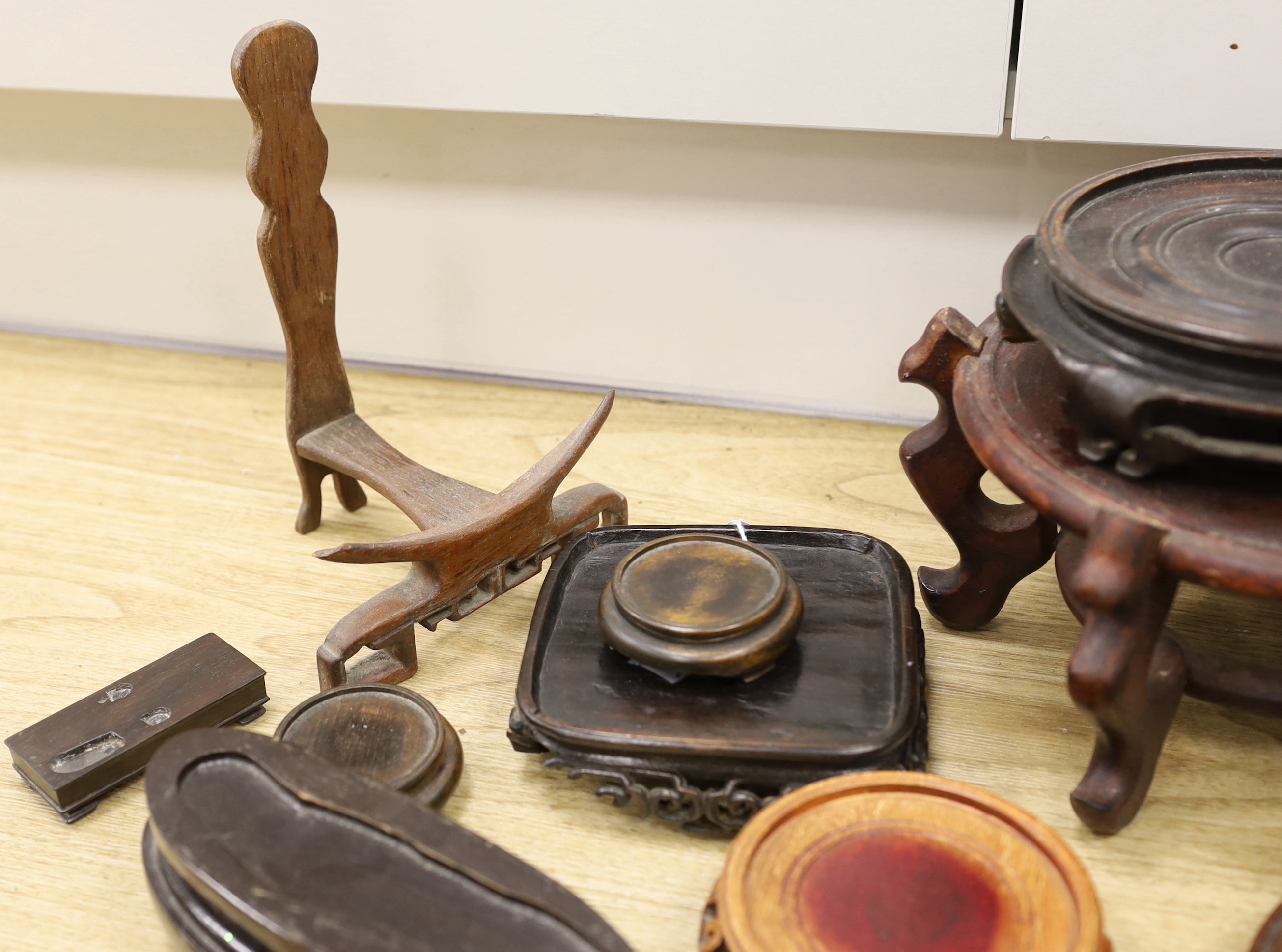 A collection of Chinese carved wooden stands and a small bamboo stand